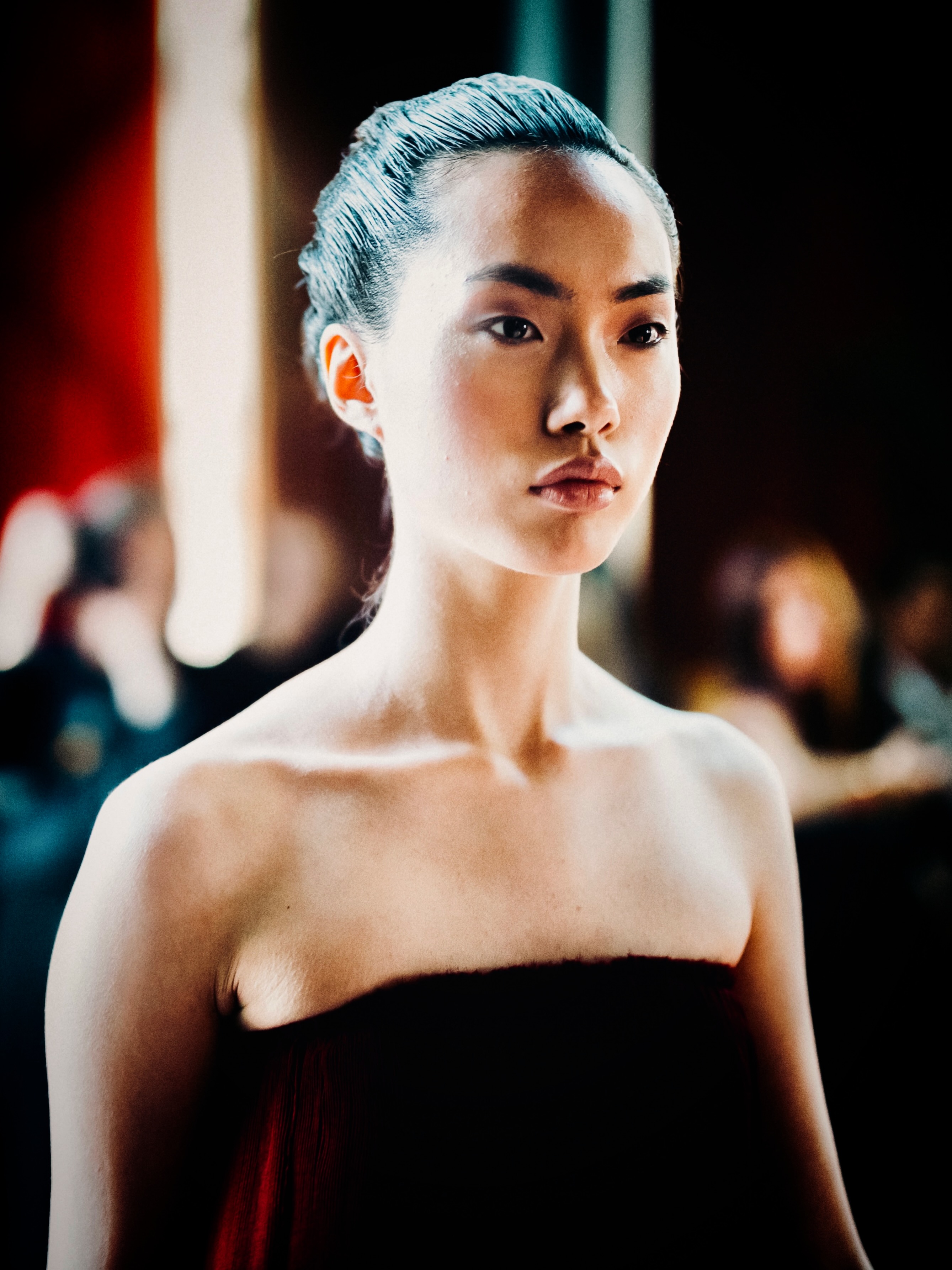 A model presents a black look on the runway.