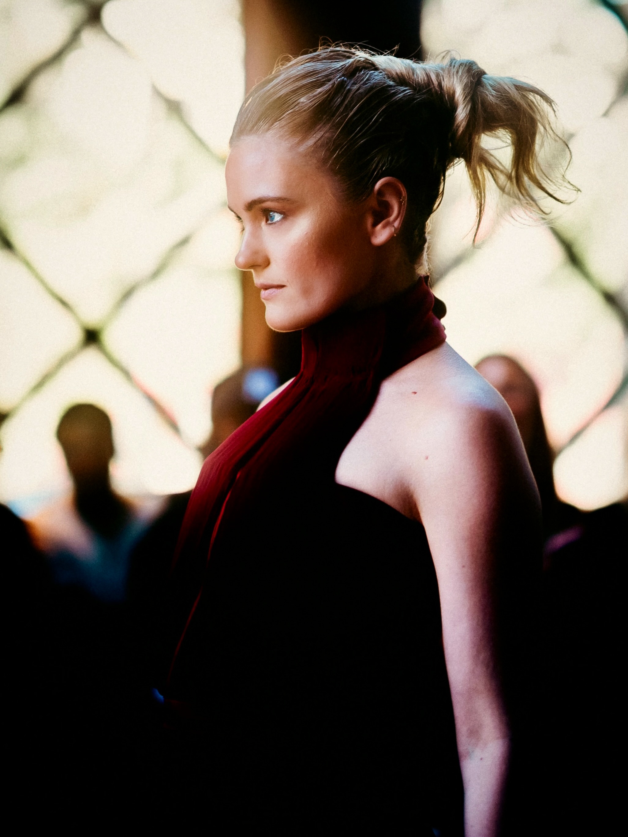 A model presents a deep red look on the runway.
