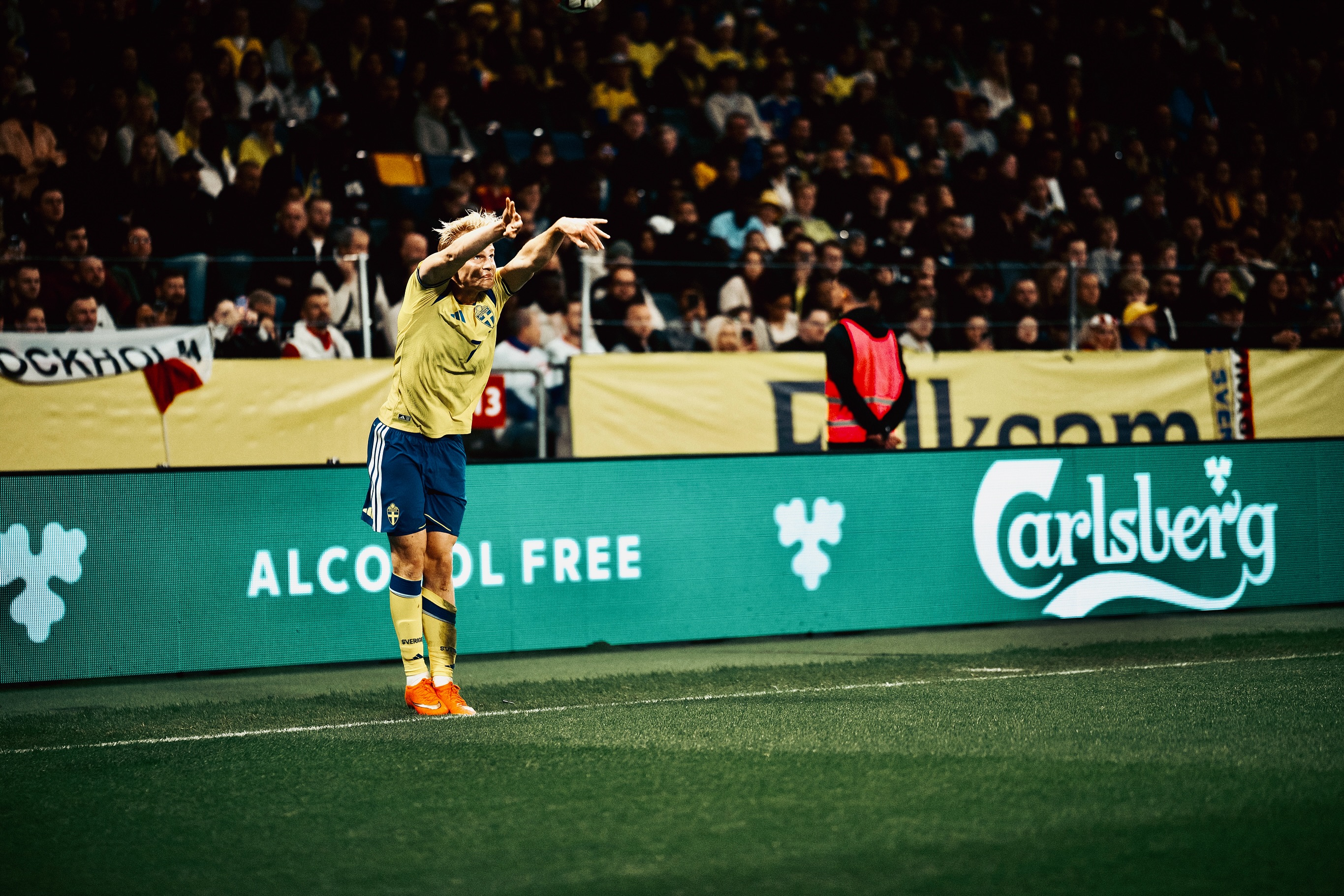 A Swedish player beside the corner flag.