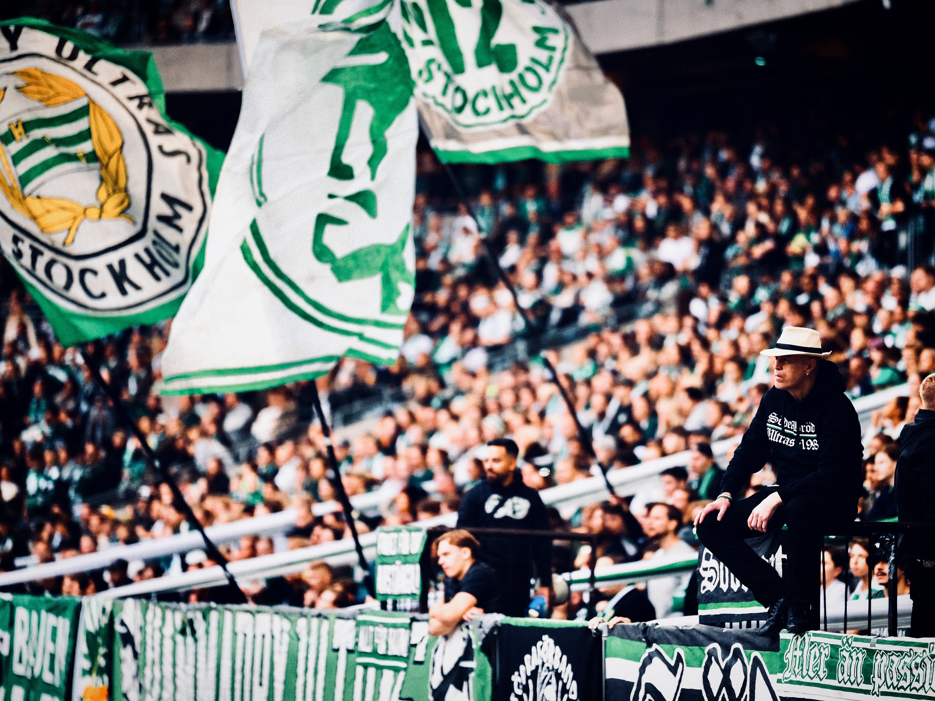 Hammarby supporters display flags in the stands.