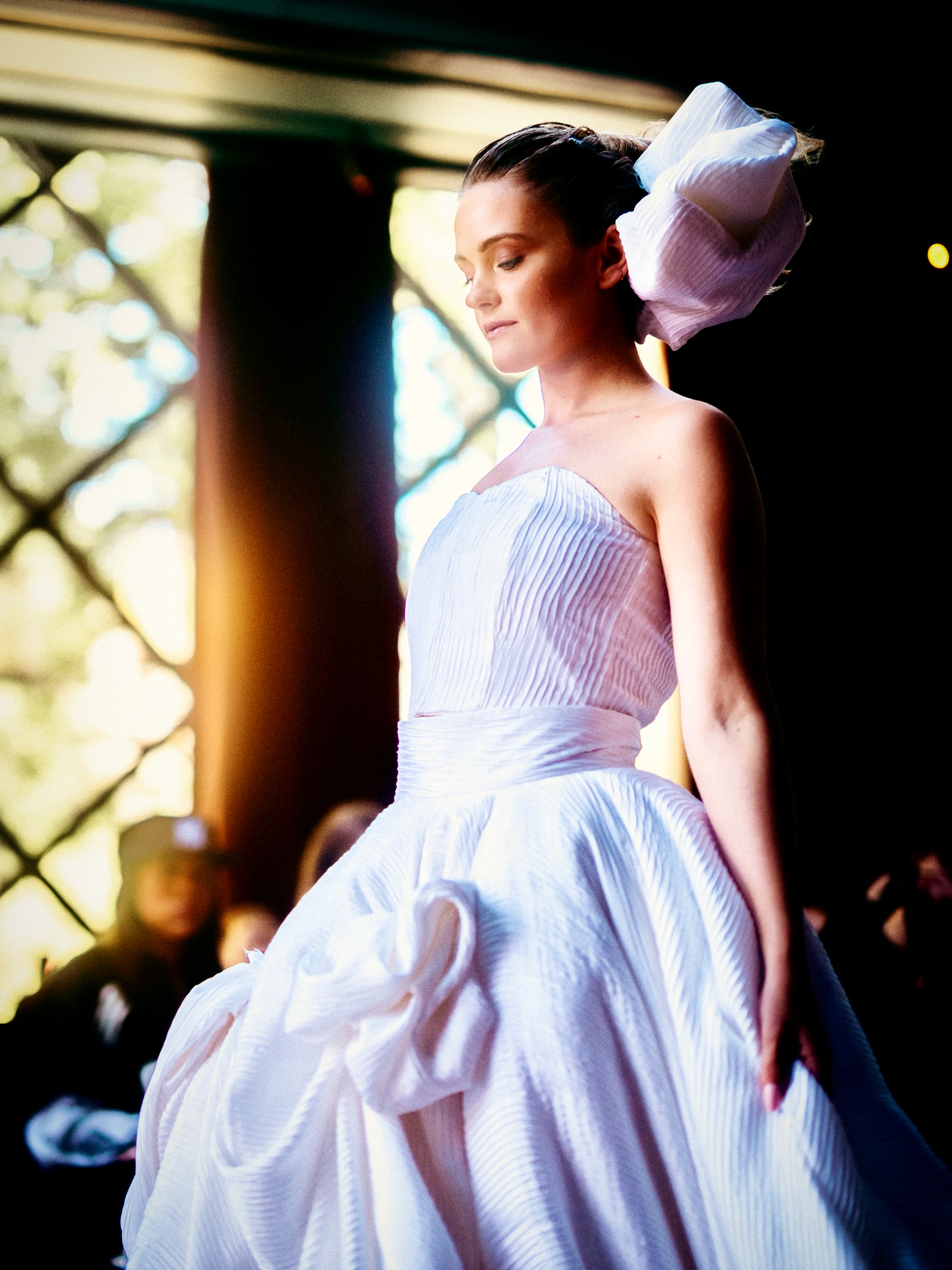 A model presents a lavender look on the runway.