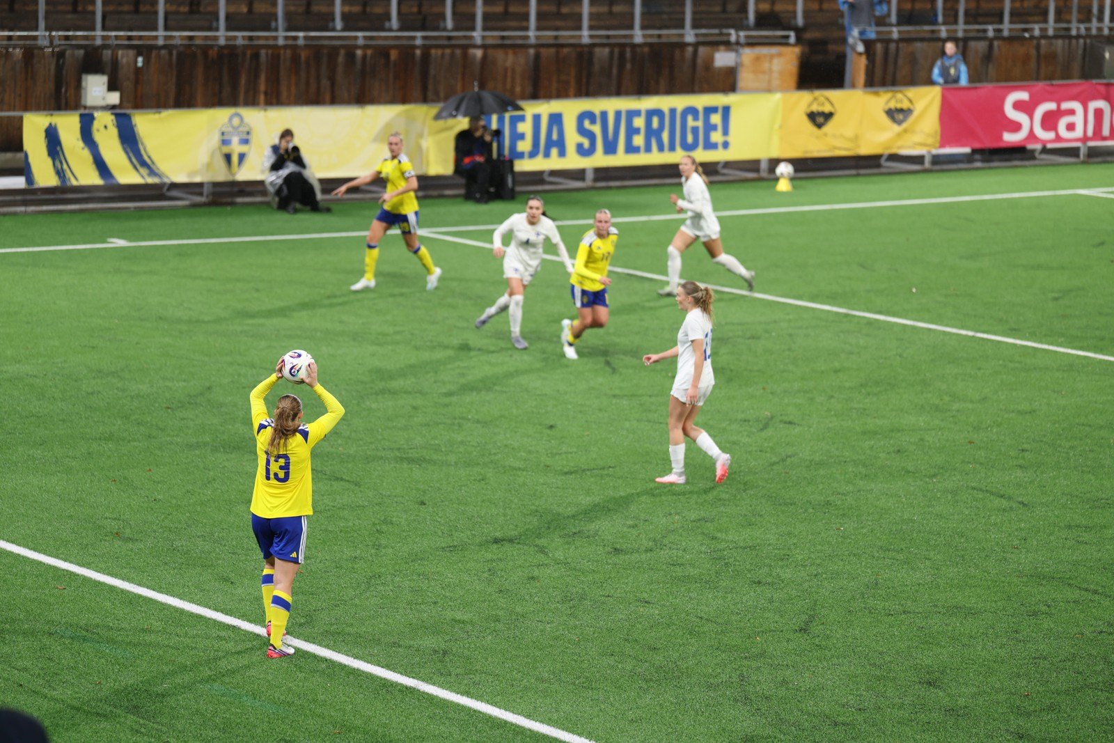 Sweden’s number 13 prepares a throw-in in a wide view of the pitch.