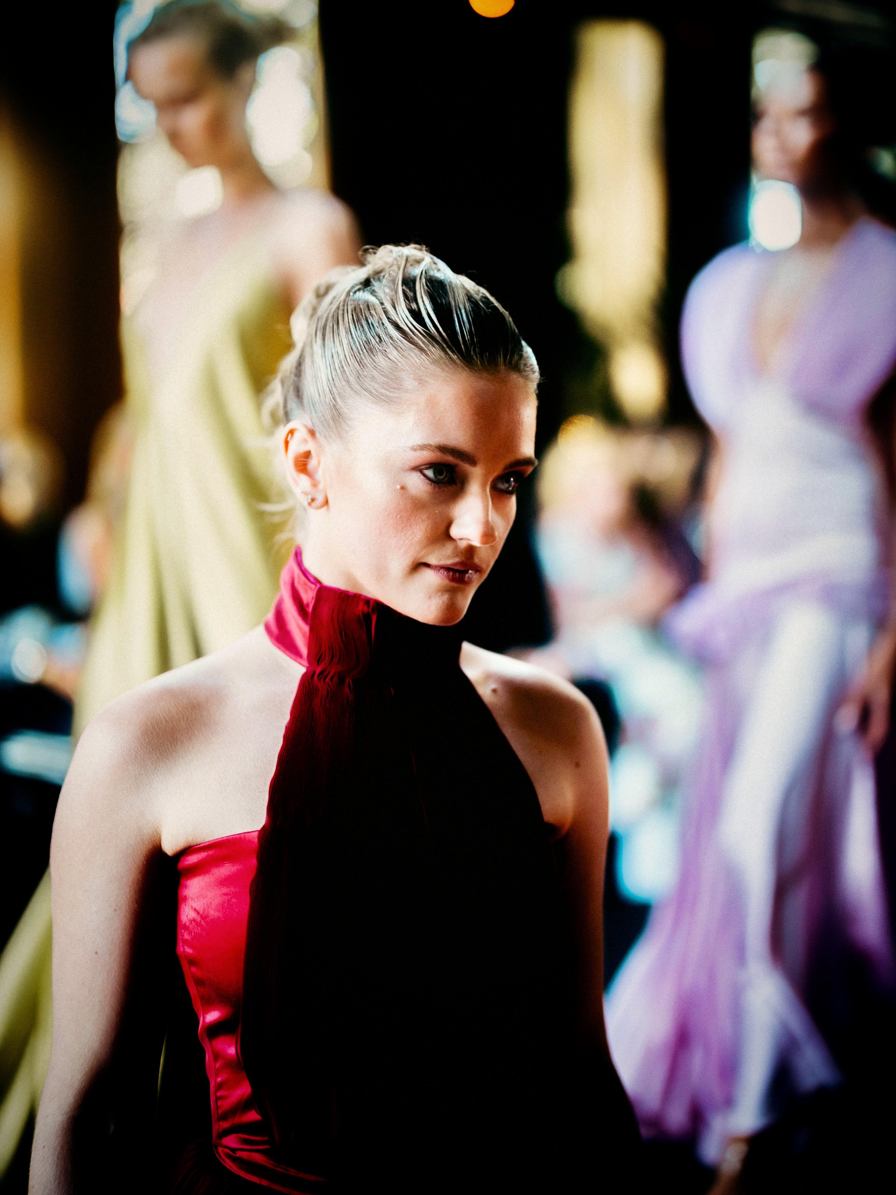 A model presents a deep red look on the runway.