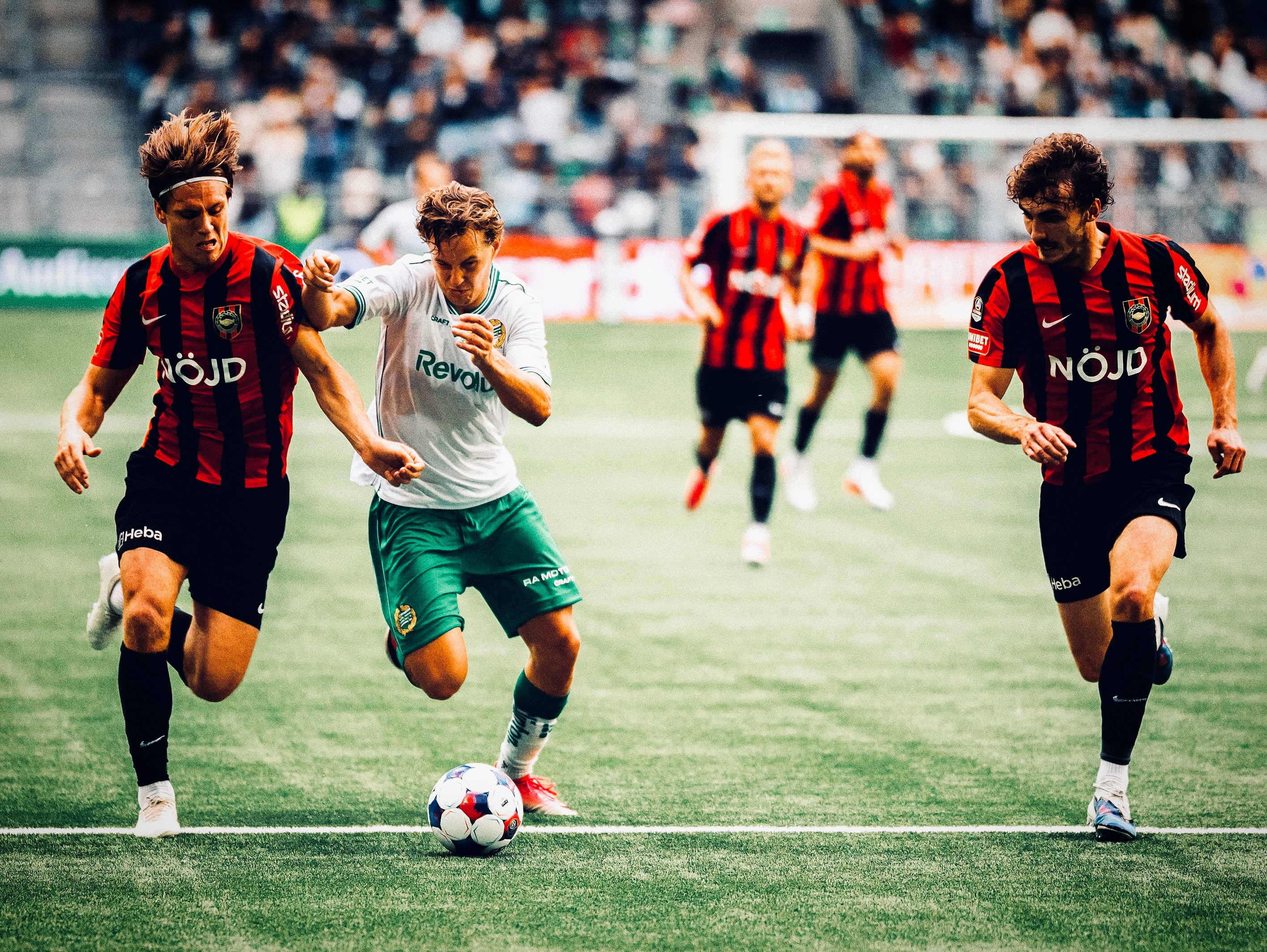 Hammarby play the ball between Brommapojkarna defenders.