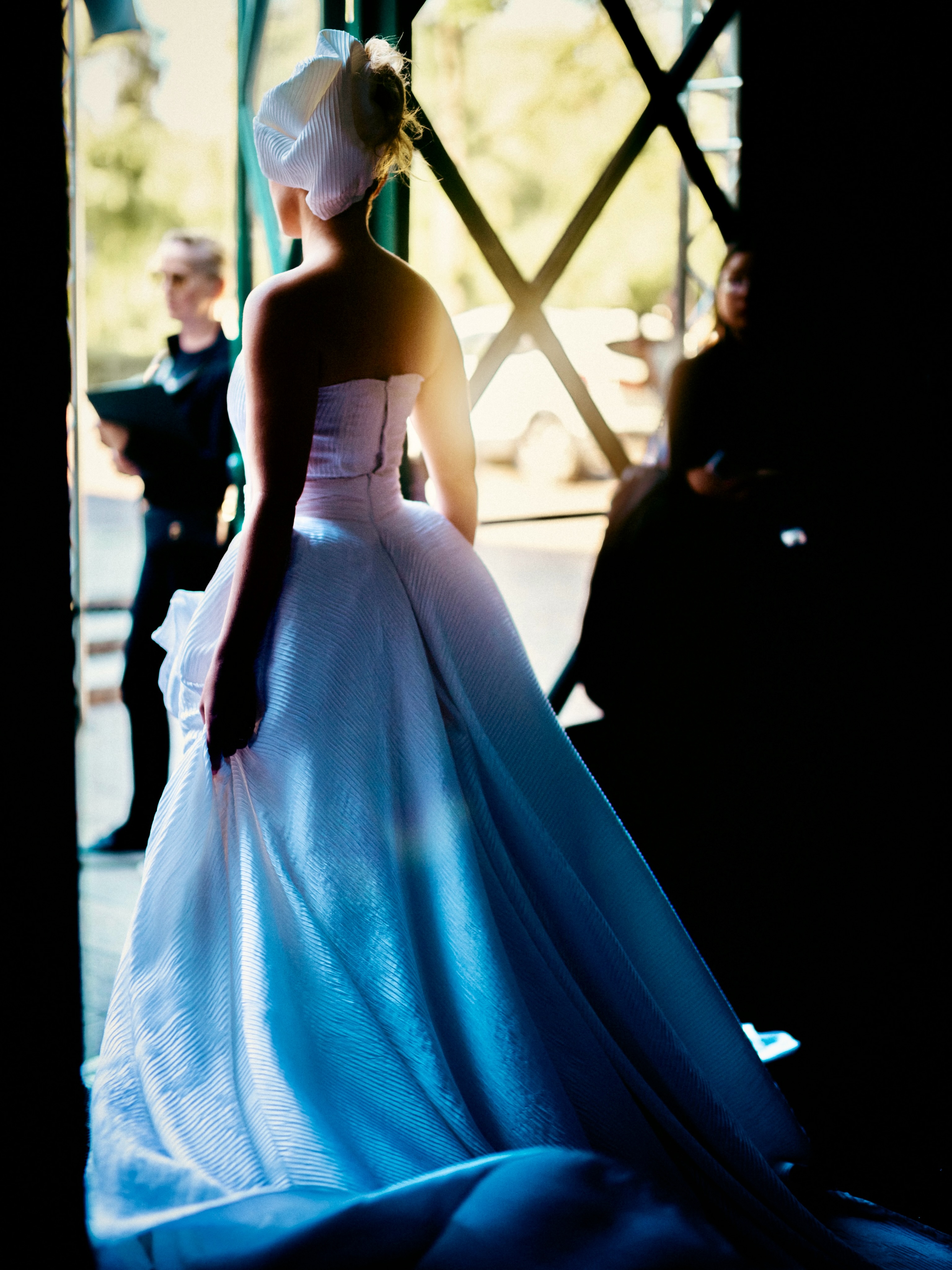 A model presents a blue look on the runway.